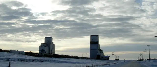 Grain elevators beside the tracks in winter